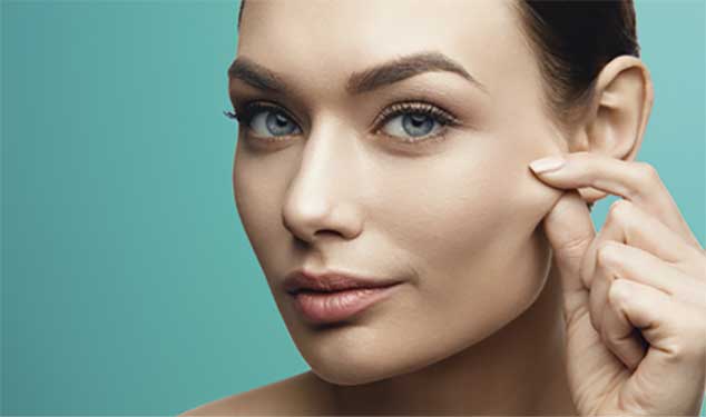 XERF radiofrequency skin tightening London - woman pinching the skin on her cheek Woman pinching the skin on her cheek, XERF radiofrequency skin tightening London